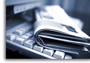 A newspaper ontop of a keyboard.